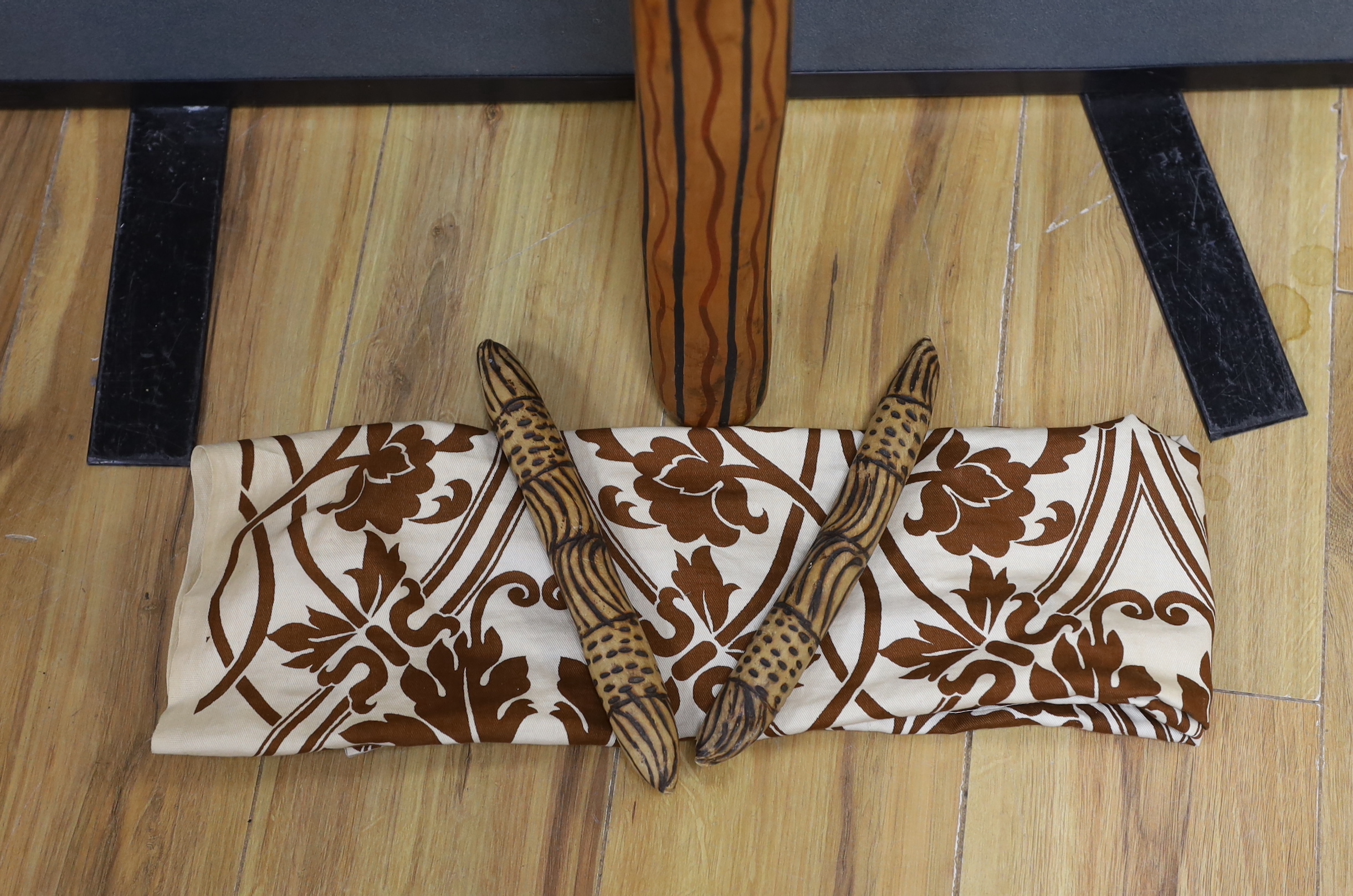 An Aboriginal decorated didgeridoo, Walpari tribe oil on canvas, a fabric painted panel and two decorated wooden sticks, canvas 50x61cm